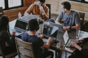 A team in an office discussing implementing cloud-native reporting